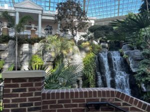 Brick wall in the foreground and waterfall in the background.