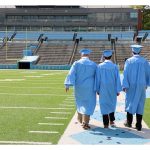 Three seniors - three best friends - walk the stadium at UNC to celebrate their upcoming graduation with Barbara Bell Photography near Chapel Hill, NC.