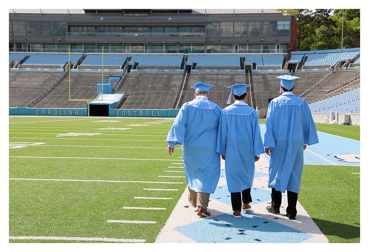 Three seniors - three best friends - walk the stadium at UNC to celebrate their upcoming graduation with Barbara Bell Photography near Chapel Hill, NC.